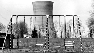 This March 30, 1979, file photo shows a cooling tower of the Three Mile Island nuclear power plant near Harrisburg, Pa., as it looms behind an abandoned playground. Forty years after Three Mile Island became synonymous with America's worst commercial nuclear power accident, the prospect of bailing out nuclear power plants is stirring debate at the highest levels of Pennsylvania and the federal government.