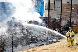 A lone firefighter contains a large blaze near the U.S. Farathane Corporation building, a plastics and manufacturing supply facility, on Tuesday, Feb. 26, 2019 in Auburn Hills, Mich. No injuries were reported.