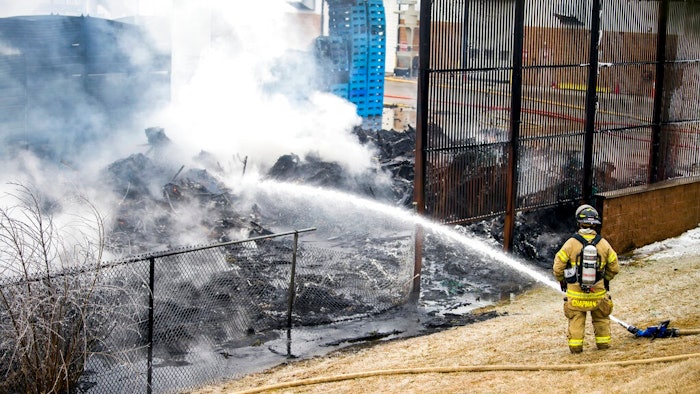 A lone firefighter contains a large blaze near the U.S. Farathane Corporation building, a plastics and manufacturing supply facility, on Tuesday, Feb. 26, 2019 in Auburn Hills, Mich. No injuries were reported.