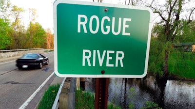 In this May 16, 2018 file photo the Rogue River flows underneath Algoma Ave. NE in Algoma Township, Mich. The Michigan DEQ is asking Wolverine World Wide to expand perfluoroalkyl and polyfluoroalkyl compounds, or PFAS, testing in the area. There’s growing evidence that long-term exposure to the perfluoroalkyl and polyfluoroalkyl compounds, or PFAS, can be dangerous, even in tiny amounts. The Environmental Protection Agency is looking at how to respond to a public push for stricter regulation of the chemicals, in production since the 1940s. A decision is expected soon.