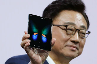 DJ Koh, President and CEO of IT and Mobile Communications, holds up the new Samsung Galaxy Fold smartphone during an event Wednesday, Feb. 20, 2019, in San Francisco.