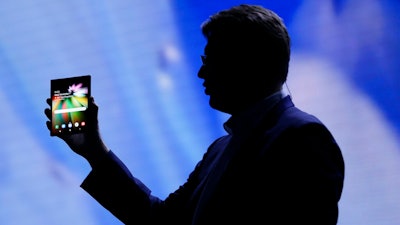In this Nov. 7, 2018 file photo,, Justin Denison, SVP of Mobile Product Development, shows off the Infinity Flex Display of a folding smartphone during the keynote address of the Samsung Developer Conference, in San Francisco. Samsung is expected to show off its latest smartphones Wednesday, Feb. 20, 2019, the latest effort by a phone maker to come up with new features compelling enough to end a sales slump.