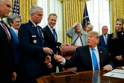 President Donald Trump hands a pen to Air Force Gen. Paul Selva after signing 'Space Policy Directive 4' in the Oval Office of the White House, Tuesday, Feb. 19, 2019, in Washington.