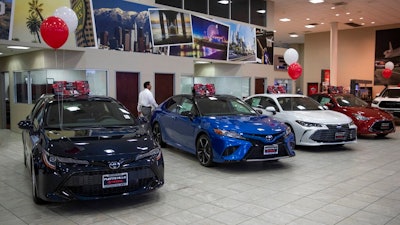 Toyota sedans are displayed in a showroom at Puente Hills Toyota Thursday, Feb. 14, 2019, in Industry, Calif. If 25 percent tariffs are fully assessed against imported parts and vehicles, and they include Canada and Mexico, the price of imported vehicles would rise more than 17 percent, or around $5,000 each, according to forecasts from IHS Markit. “I think it would be harmful to the whole economy,” said Howard Hakes, president of Hitchcock Automotive, which has three Toyota showrooms in metro Los Angeles.