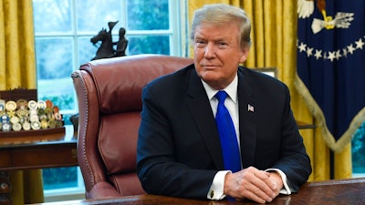 In this Friday, Feb. 22, 2019, file photo, President Donald Trump listens during his meeting with Chinese Vice Premier Liu He in the Oval Office of the White House in Washington. Trump said Sunday he will extend a deadline to escalate tariffs on Chinese imports, citing 'substantial progress' in weekend talks between the two countries.