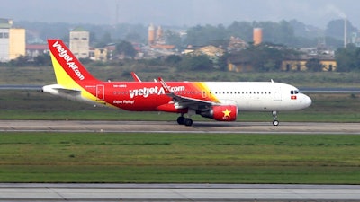 In this Feb. 19, 2019, photo, a Vietjet airplane taxis on the runway in Noi Bai airport, Hanoi, Vietnam. U.S. President Donald Trump and Vietnamese President Nguyen Phu Trong have presided over a signing ceremony for several commercial trade deals in Hanoi, including agreements to sell 110 Boeing aircraft worth billions of dollars to the booming Southeast Asian country.