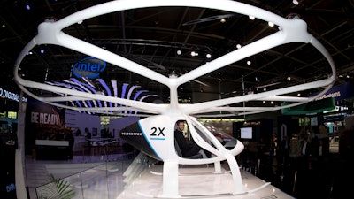 In this Monday, June 11, 2018 file photo, the multi-rotor electric aircraft Volocopter 2x, displayed at the electronic fair Cebit in Hannover, Germany. The operator of Frankfurt’s international airport is working on a concept for future autonomous air taxi services in cooperation with the Volocopter GmbH.