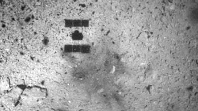 This image released by the Japan Aerospace Exploration Agency (JAXA) shows the shadow, center above, of the Hayabusa2 spacecraft after its successful touchdown on the asteroid Ryugu Friday, Feb. 22, 2019. Hayabusa2 touched down on the distant asteroid Friday on a mission to collect material that could provide clues to the origin of the solar system and life on Earth.