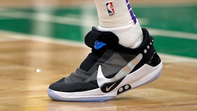 In this Feb. 7, 2019 photo, Boston Celtics forward Jayson Tatum stands at the bench area during an NBA basketball game against the Los Angeles Lakers in Boston. He is wearing Nike's latest performance basketball shoes, which from concept to reality, took about three years to put together. Or 30 years, depending on how you count. The Nike Adapt BB _ a self-lacing smart shoe that can be controlled by a smartphone _ gets released to the public on Sunday, Feb. 17, 2019, a date that just happens to coincide with the NBA All-Star Game in Charlotte. It has a motor embedded within the shoe, and a hefty $350 price tag. It has a motor embedded within the shoe, and a hefty $350 price tag.