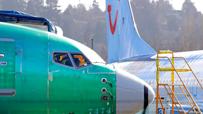 In this March 13, 2019, file photo a worker walks past an engine on a Boeing 737 MAX 8 airplane being built for American Airlines at Boeing Co.'s Renton assembly plant in Renton, Wash. On Wednesday, March 27, the Senate aviation subcommittee will examine how the FAA oversees safety in the commercial aviation industry. Expected to testify is the Transportation Department's inspector general, who is conducting a separate probe of the FAA's decision to approve the Boeing 737 Max aircraft, the type of plane that crashed in October in Indonesia, and this month in Ethiopia.
