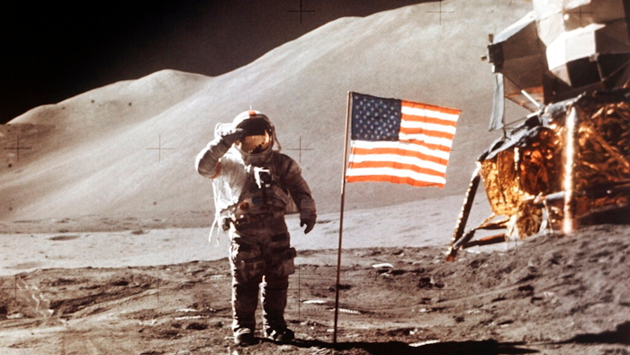 In this July 30, 1971 photo made available by NASA, Apollo 15 Lunar Module Pilot James B. Irwin salutes while standing beside the fourth American flag planted on the surface of the moon. On Tuesday, March 26, 2019, Vice President Mike Pence called for landing astronauts on the moon within five years.