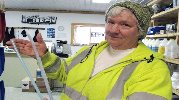 Ruth Goodrich of Goodrich's Maple Farm in Danville, Vt., holds squirrel-damaged maple sap tubing, right, and new tubing, left, in the farm's equipment shop.