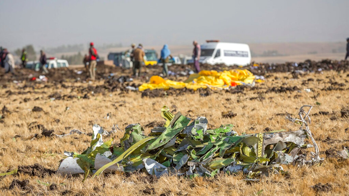 Parts of the plane wreckage with rescue workers at the crash site at Bishoftu, or Debre Zeit, outside Addis Ababa, Ethiopia, Monday, March 11, 2019, where Ethiopia Airlines Flight 302 crashed Sunday. Investigators are trying to determine the cause of a deadly crash Sunday involving a new aircraft model touted for its environmentally friendly engine that is used by many airlines worldwide.