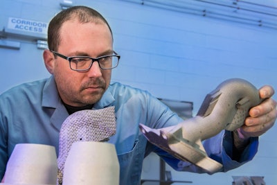 Army researcher Dr. Brandon McWilliams, a leader in the efforts to advance 3D printed metals, holds a sample part created from powder at the US Army US Army Combat Capabilities Development Command's Army Research Laboratory at Aberdeen Proving Ground, Md.