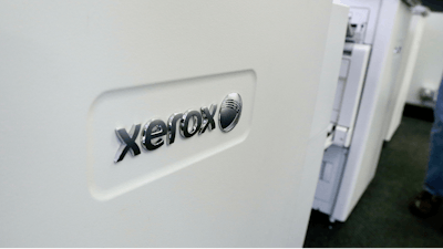 This Tuesday, May 24, 2016 file photo shows Xerox copiers at a store, in North Andover, Mass. Xerox is reorganizing under a new holding company, saying that it will have more strategic, operational and financial flexibility. Xerox Corp. said in a regulatory filing Thursday, March 7, 2019 that the reorganization won’t change its business operations, directors or executive officers.