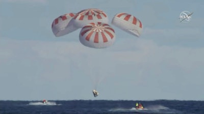 This image provided by NASA shows SpaceX's Dragon capsule carrying a test dummy splashed down into the Atlantic ocean off the Florida coast, Friday, March 8, 2019. It marks the first time in 50 years that a capsule designed for astronauts returned from space by plopping into the Atlantic.