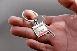 In this March 21, 2018, file photo a Thai Lion Air employee displays a ceremonial key to the company's newest plane, Boeing's first 737 MAX 9 jet, following a delivery ceremony to the airline in Seattle. The United States and many other countries have grounded the Max 8s and larger Max 9s as Boeing faces the challenge of proving the jets are safe to fly amid suspicions that faulty sensors and software contributed to the two crashes in less than five months.