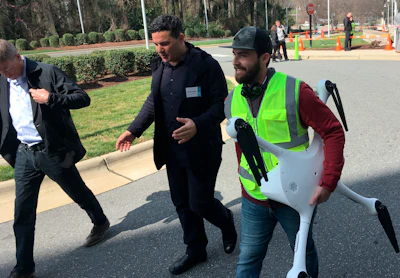 Matternet CEO Andreas Raptopoulos walks next to an operator carrying a drone used for delivery of medical specimens after a flight at WakeMed Hospital in Raleigh, North Carolina on March 26, 2019. Matternet and UPS partnered with the hospital to start commercial flights of medical samples across the WakeMed campus.