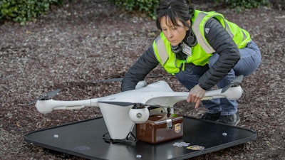In this March 2019 photo provided by UPS, a drone operator handles a drone used for carrying medical specimens at a landing area at WakeMed hospital in Raleigh, N.C. UPS, Matternet and WakeMed announced a program on Tuesday, March 26, 2019, to use drones for commercial flights of blood samples and other medical specimens at the North Carolina hospital campus.