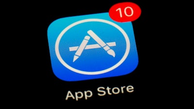 This March 19, 2018, file photo shows Apple's App Store app in Baltimore. As its iPhone sales slip, Apple has been touting its growing digital-services business as the engine that will keep profits up. But there may be a catch. Apple currently pockets a generous commission on all subscriptions and other purchases made on iPhone apps. But a brewing backlash against the company’s cut, which ranges from 15 to 30 percent, could undercut the app store’s profitability just as Apple is counting on it most.