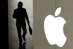 In this Jan. 3, 2019, file photo a man leaves an Apple store in Beijing. A trade court judge will recommend banning some iPhones from being imported into the U.S. after concluding Apple's best-selling device infringed on technology owned by mobile chip maker Qualcomm. The U.S. Trade International Trade Commission decision is the latest twist in a bitter legal dispute between Qualcomm and Apple over the rights to some of the technology that enables the iPhone to connect to the internet.