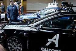 Pittsburgh Mayor William Peduto, left, checks out autonomous vehicles designed by Aurora Innovations, front, and Argo AI, rear, after signing an executive order outlining objectives and expectations for the safe testing and development of autonomous vehicles in Pittsburgh, Monday, March 4, 2019.