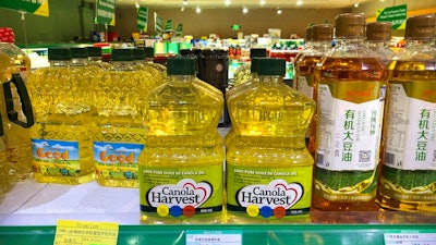 Bottles of Canola Harvest brand canola oil, manufactured by Canadian agribusiness firm Richardson International, are seen on the shelf of a grocery store in Beijing, Wednesday, March 6, 2019. One of Canada's largest grain processors said Tuesday that China has revoked its permit to export canola there, a move that some saw as retaliation for the Canadian government's arrest of a top executive for the Chinese tech giant Huawei.