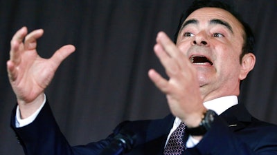 In this May 12, 2016, photo, then Nissan Motor Co. President and CEO Carlos Ghosn speaks during a joint press conference with Mitsubishi Motors Corp. in Yokohama, near Tokyo. Ghosn, released on bail, is asking for a court's approval to attend the Japanese automaker's board meeting Tuesday, March 12, 2019. It is unclear if Ghosn could attend. Japanese media say prosecutors will likely argue against his attendance.