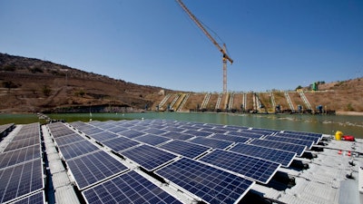 An island of solar panels floats in a pond at the Los Bronces mining plant, about 65 kilometers (approximately 40 miles) from Santiago, Chile, Thursday, March 14, 2019. The island of solar panels could give purpose to mine refuse in Chile by using them to generate clean energy and reduce water evaporation.