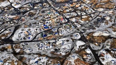 This Feb. 13, 2017 aerial photo shows the Oceti Sakowin camp, where people have gathered to protest the Dakota Access pipeline on federal land in Cannon Ball, N.D. South Dakota Gov. Kristi Noem says she's proposing legislation ahead of the Keystone XL oil pipeline's construction that would create a legal avenue to pursue out-of-state money that funds protests aimed at slowing construction. Noem's bills come after opponents of the Dakota Access oil pipeline staged large protests that resulted in 761 arrests in southern North Dakota over a six-month span beginning in late 2016. The state spent tens of millions of dollars policing the protests.