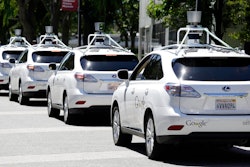 A row of driverless SUVs being tested as part of Google's technology initiative.