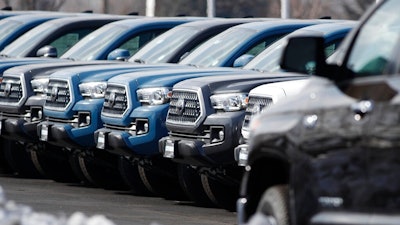 In this Wednesday, Feb. 27, 2019, file photograph, a long row of unsold 2019 Tacoma pickup trucks sits at a Toyota dealership in Lakewood, Colo. On Wednesday, March 13, the Commerce Department releases its January report on durable goods.
