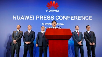 Huawei Rotating Chairman Guo Ping, center, speaks in front of other executives during a press conference in Shenzhen, China's Guangdong province, Thursday, March 7, 2019. Chinese tech giant Huawei is launching a U.S. court challenge to a law that labels the company a security risk and would limit its access to the American market for telecom equipment.