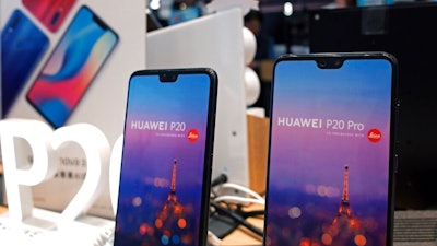 Huawei's mobile phones are displayed at a telecoms service shop in Hong Kong, Friday, March 29, 2019. Chinese tech giant Huawei's deputy chairman defended its commitment to security Friday after a stinging British government report added to Western pressure on the company by accusing it of failing to repair dangerous flaws in its telecom technology.