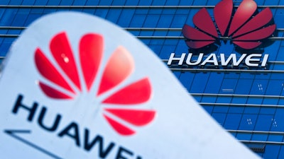 This Dec. 18, 2018 file photo shows company signage on display near the Huawei office building at its research and development center in Dongguan, in south China's Guangdong province. The Chinese tech giant Huawei has pleaded not guilty to U.S. charges that it stole trade secrets from T-Mobile. A company representative entered the pleas Thursday, Feb. 28, 2019, in federal court in Seattle, where a 10-count indictment was unsealed in January. Charges include conspiracy to steal trade secrets, attempted theft of trade secrets, wire fraud and obstruction of justice.