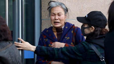 A relative of passengers on board the missing Malaysia Airlines Flight 370 (MH370) weeps after a meeting with Chinese Foreign Ministry officials in Beijing, Friday, March 8, 2019. Friday marked the fifth anniversary of the disappearance of MH370, which vanished March 8, 2014 while en route from Kuala Lumpur to Beijing.
