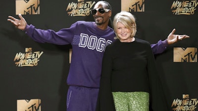 In this May 7, 2017 file photo, Snoop Dogg, left, and Martha Stewart pose in the press room at the MTV Movie and TV Awards in Los Angeles. The domestic diva is now partnering with Canada's Canopy Growth Corp. to develop new products containing CBD, a compound derived from hemp and marijuana that doesn't cause a high. Stewart's tie-up with Canopy may not be a surprise to her fans. In 2015, she baked brownies on 'The Martha Stewart Show' with marijuana aficionado Snoop Dogg, and hinted that Snoop could add a little weed if he wanted to.