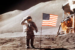 In this July 30, 1971 photo made available by NASA, Apollo 15 Lunar Module Pilot James B. Irwin salutes while standing beside the fourth American flag planted on the surface of the moon. On Tuesday, March 26, 2019, Vice President Mike Pence called for landing astronauts on the moon within five years.