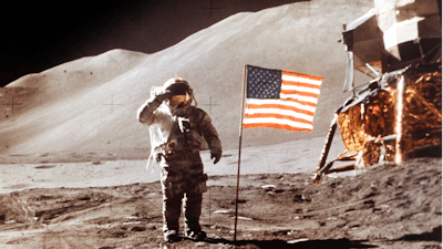 In this July 30, 1971 photo made available by NASA, Apollo 15 Lunar Module Pilot James B. Irwin salutes while standing beside the fourth American flag planted on the surface of the moon. On Tuesday, March 26, 2019, Vice President Mike Pence called for landing astronauts on the moon within five years.