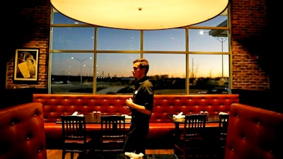 In this Jan. 9, 2019, file photo tables sit empty during dinnertime at Rocket City Tavern near numerous federal agencies in Huntsville, Ala. The Labor Department has issued its long-awaited proposed regulations on overtime. The proposal would raise the pay threshold at which workers would be exempt from overtime to $35,308 from the current $23,660. The proposed rules, which the department says would make more than one million workers eligible for overtime, are most likely to affect workers with jobs like shift supervisor or assistant manager at restaurants, retailers and manufacturing companies.