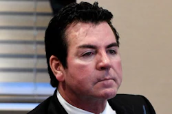 In this file photo, Papa John's founder and CEO John Schnatter attends a meeting in Louisville. Papa John’s has reached a settlement agreement with Schnatter that will see him step down from the pizza chain’s board once an independent director that is mutually acceptable replaces him.