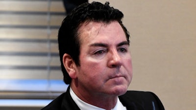 In this file photo, Papa John's founder and CEO John Schnatter attends a meeting in Louisville. Papa John’s has reached a settlement agreement with Schnatter that will see him step down from the pizza chain’s board once an independent director that is mutually acceptable replaces him.