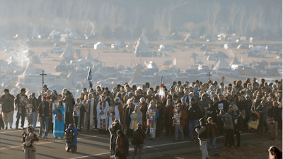 This Nov. 11, 2016 file photo shows more than 500 clergy from across the country gathered for a 'Clergy for Standing Rock' march on N.D. Highway 1806 near Cannon Ball, N. D., from the Oceti Sakowin Camp to the Cantapeta Creek bridge to demonstrate their solidarity for the Dakota Access Pipeline protesters. South Dakota Gov. Kristi Noem says she's proposing legislation ahead of the Keystone XL oil pipeline's construction that would create a legal avenue to pursue out-of-state money that funds protests aimed at slowing construction. Noem's bills come after opponents of the Dakota Access oil pipeline staged large protests that resulted in 761 arrests in southern North Dakota over a six-month span beginning in late 2016. The state spent tens of millions of dollars policing the protests.