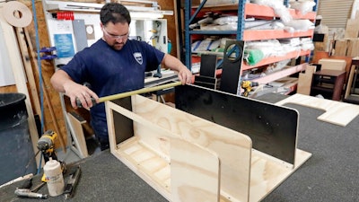 In this July 11, 2018, file photo a worker assembles interior cabinets for a boat at Regal Marine Industries in Orlando, Fla. Last week the Commerce Department said factory orders rose 0.1 percent in January, a tiny increase that matched December’s reading but fell short of many economists’ forecasts.
