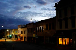In this Oct. 28, 2017, file photo the storefront window of a portrait studio is lit up along a downtown street at dusk in Lumberton, N.C. Although small businesses vary widely in terms of size, industry and issues, they do appear to be generally united by a growing uneasiness about the economy. Several surveys and economic reports released in recent weeks show that company owners have more trust in their businesses than the national or local economy, and that they’re running their businesses more conservatively in response to uncertainty about overall business conditions.