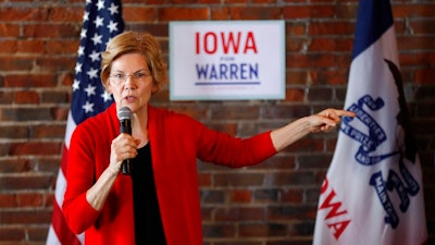 In this March 1, 2019, file photo, Democratic presidential candidate Sen. Elizabeth Warren speaks to local residents during an organizing event in Dubuque, Iowa. Warren is everywhere in the first three months of her presidential campaign: 11 states as of Tuesday. But where she's not is at the top of early 2020 polls.