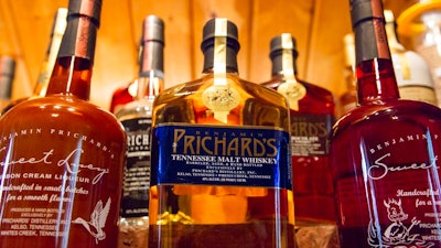 In this March 19, 2015 file photo, bottles of spirits are on display at the Prichard's Distillery in Nashville, Tenn. A spirits industry trade group says the tariff-induced hangover for American whiskey producers became more painful in late 2018. The Distilled Spirits Council said Thursday, March 20, 2019 that a downturn in American whiskey exports accelerated at the end of last year, especially in the European Union _ the industry’s biggest overseas market.