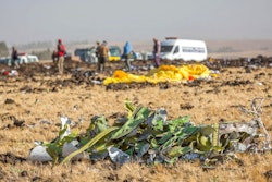 Parts of the plane wreckage with rescue workers at the crash site at Bishoftu, or Debre Zeit, outside Addis Ababa, Ethiopia, Monday, March 11, 2019, where Ethiopia Airlines Flight 302 crashed Sunday. Investigators are trying to determine the cause of a deadly crash Sunday involving a new aircraft model touted for its environmentally friendly engine that is used by many airlines worldwide.