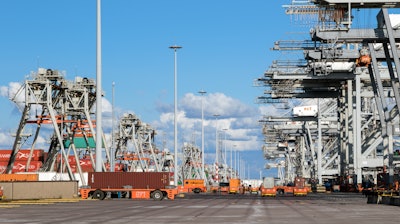 Automated Guided Vehicles moving shipping containers in a container terminal in the port of Rotterdam in the Netherlands.