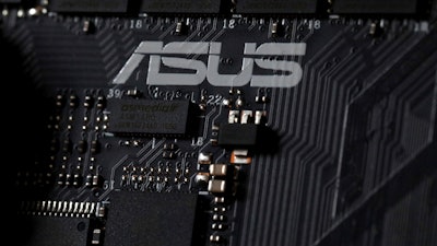 This Feb 23, 2019, photo shows the inside of a computer with the ASUS logo in Jersey City, N.J. Security researchers say hackers infected tens of thousands of computers from the Taiwanese vendor ASUS with malicious software for months last year through the company’s online automatic update service. Kaspersky Labs said Monday, March 25, that the exploit likely affected more than 1 million computers from the world’s No. 5 computer company, though it was designed to surgically install a backdoor in a much smaller number of PCs.